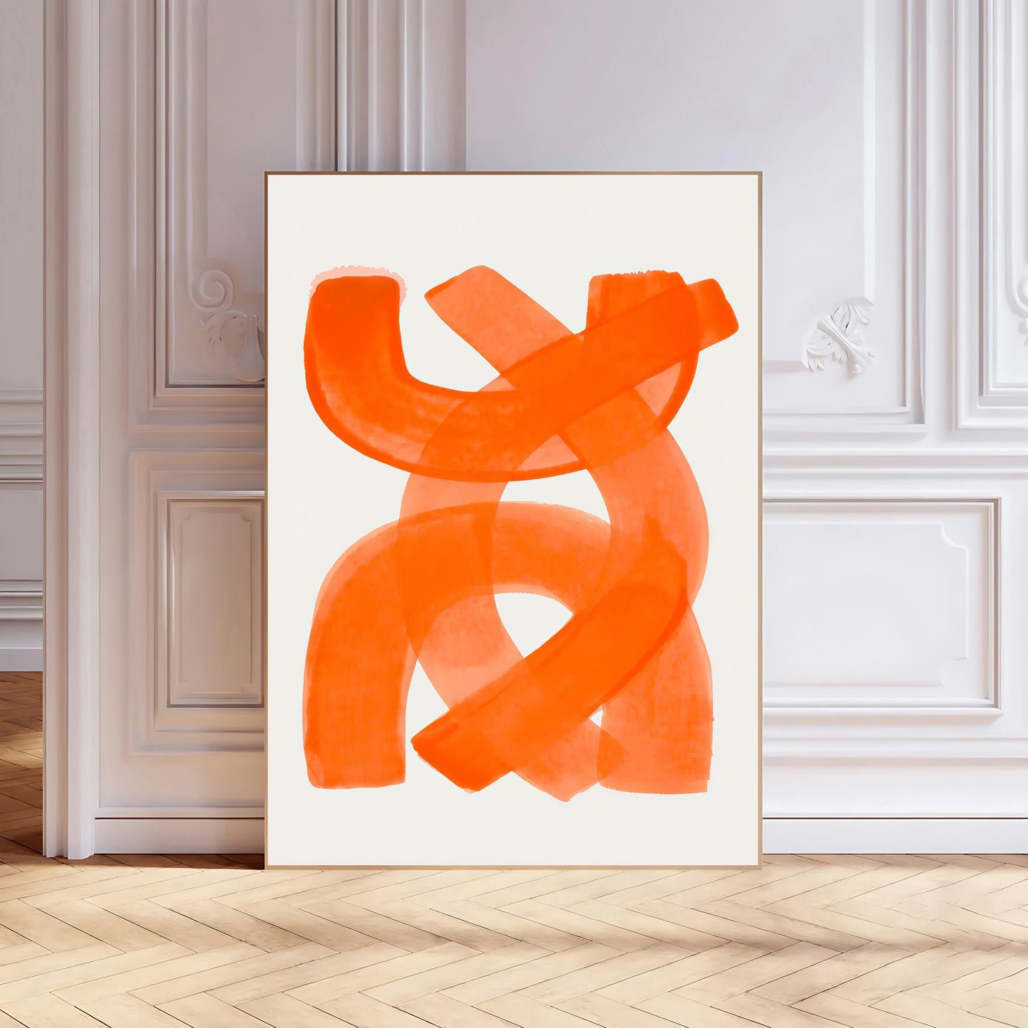 Abstract orange artwork on a white wall in a room with wooden flooring.