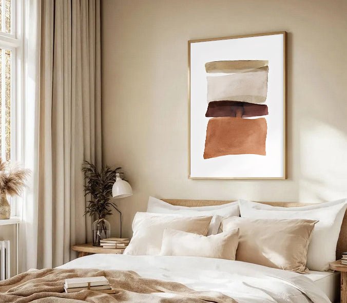 Neatly made bed with pillows and a framed abstract art piece on the wall in a bedroom.
