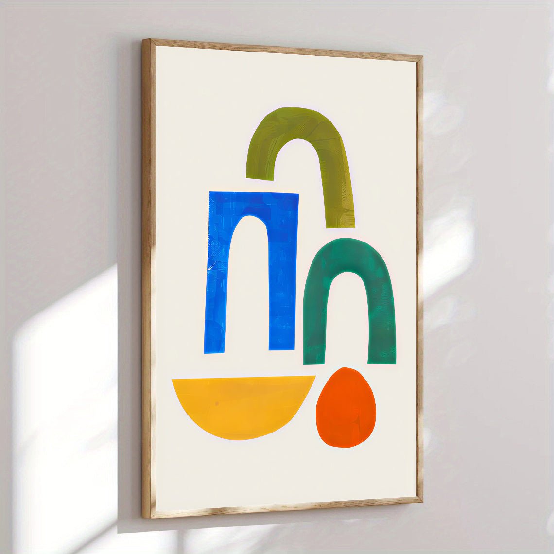 Framed abstract art with colorful shapes on a white wall