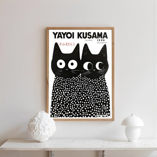 Framed artwork of two black cats with white dots by Yayoi Kusama cat print on a white wall.