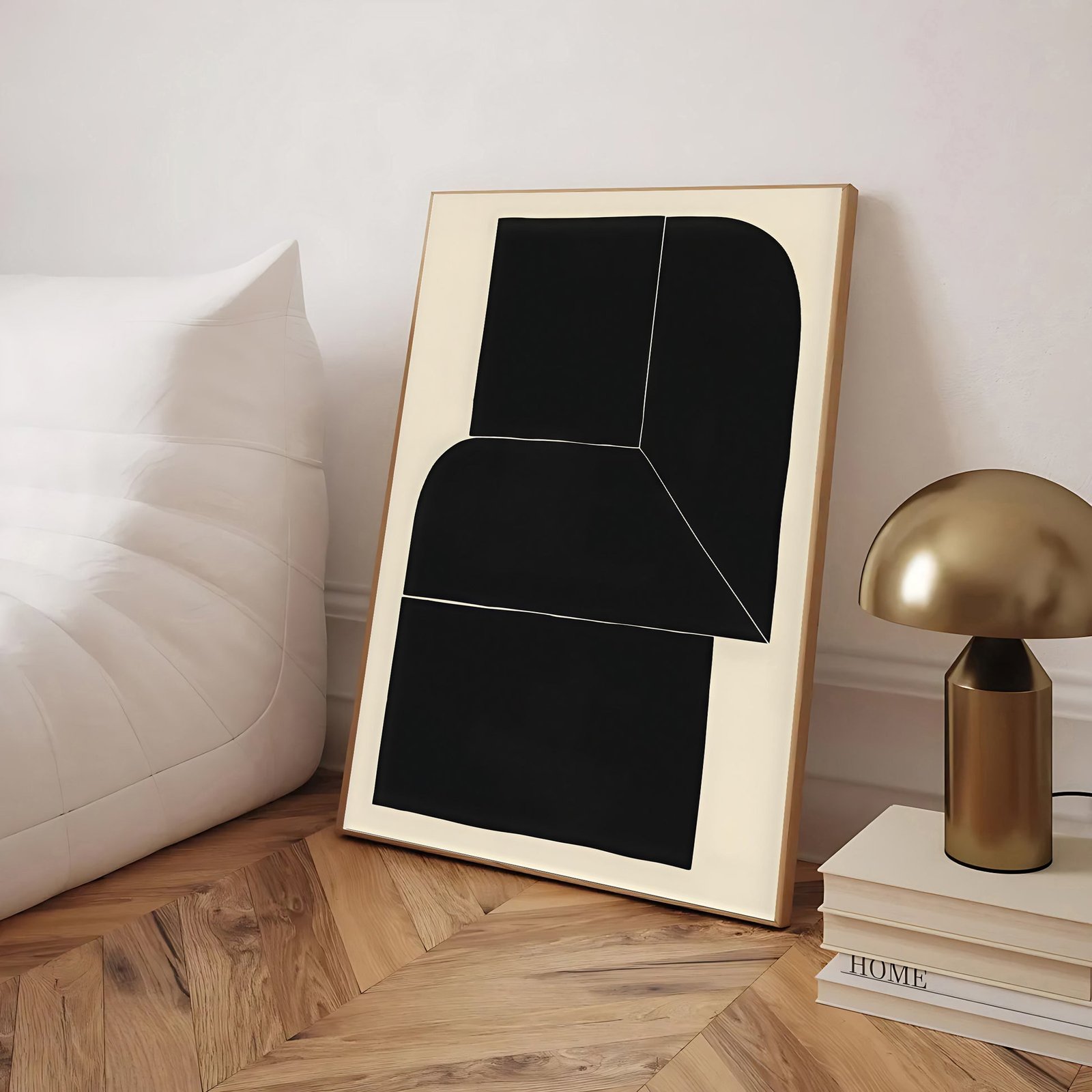Abstract art piece with black shapes in a wooden frame on a wooden floor.